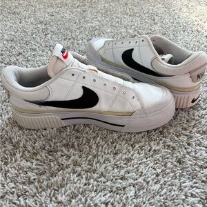 Nike White Low-Top Sneakers with Black Swoosh and Cream Accents